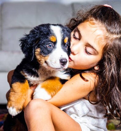child with bernese puppy e1629195359177